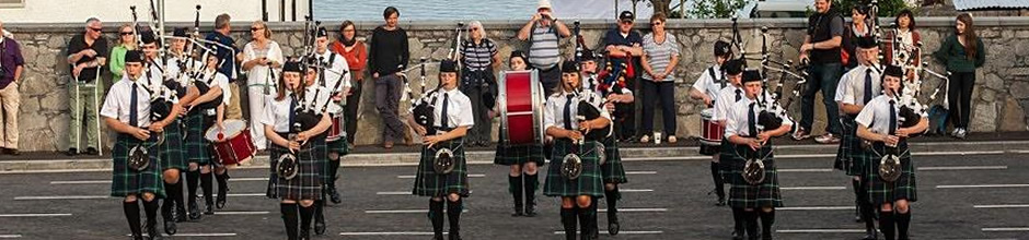 The Ullapool and District Junior Pipe Band playing at the ferry car park
